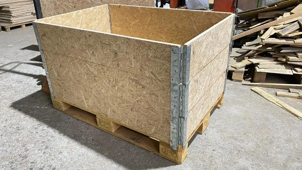 A collapsible crate with steel edge sections and strand board panels