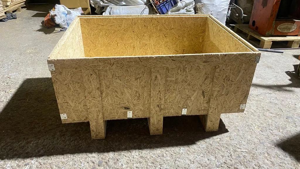 An open-topped crate built from oriented strand board on a matching base