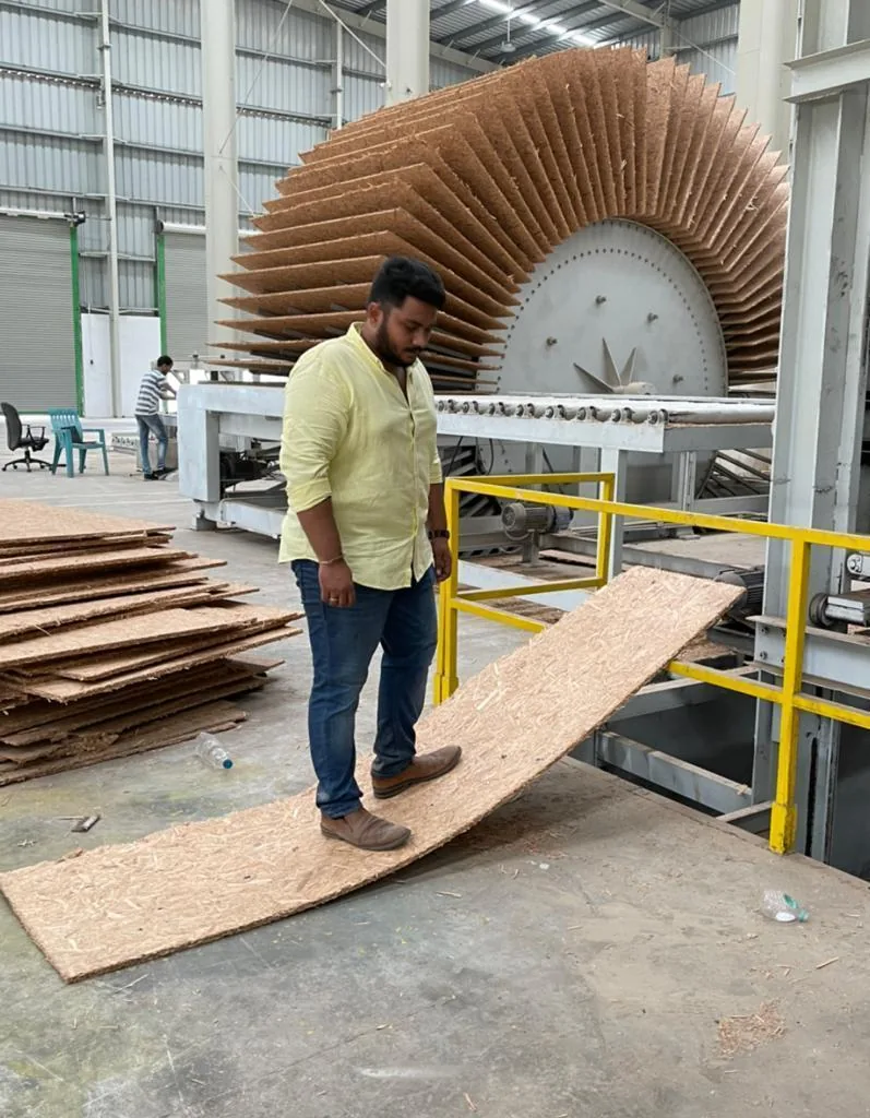 Freshly pressed boards fanned across a star cooler on the plant floor